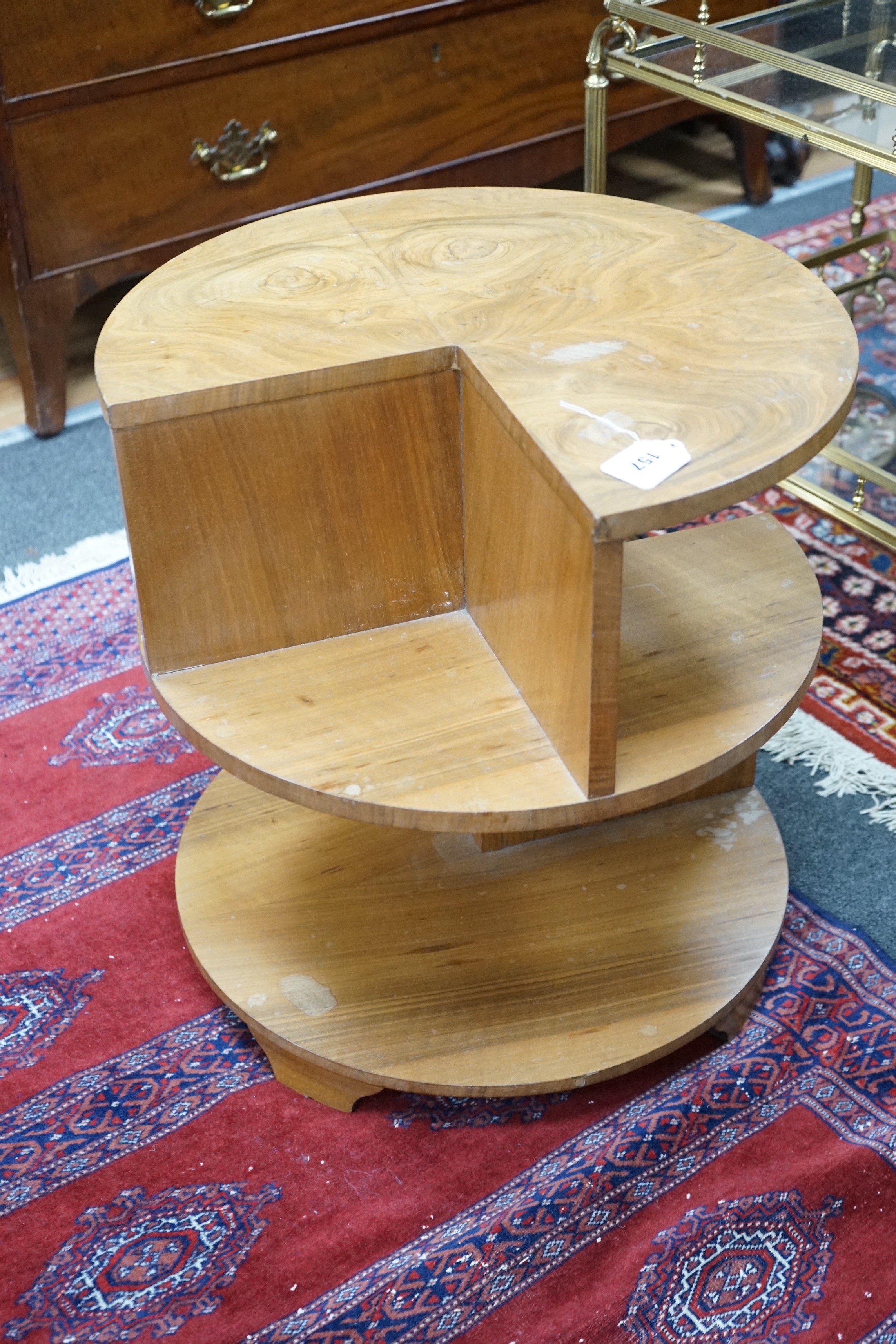 An Art Deco style walnut circular three tier occasional table, diameter 50cm, height 53cm